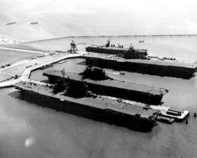 Carriers Saratoga (CV-2), Enterprise (CV-6), Hornet (CV-12) and San Jacinto (CVL-30) docked at Alameda, September of 1945.